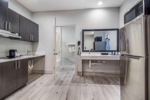 a kitchen with a sink and a refrigerator at Studio 6 Deer Park, Tx in Deer Park