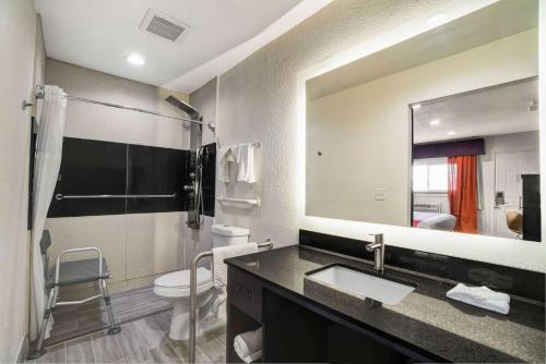 a bathroom with a sink and a toilet and a mirror at Motel 6 Bellville, OH in Bellville
