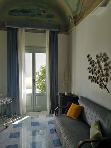 a living room with a couch in front of a door at 1940 Luxury Accommodations by Wonderful Italy in Ostuni
