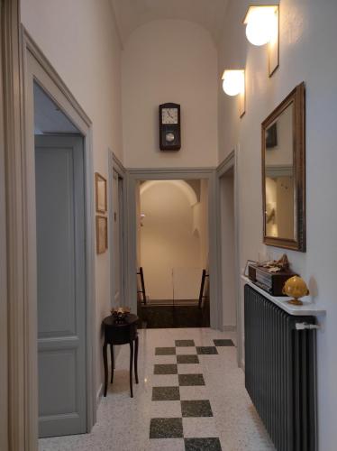 a hallway with a door and a table and a clock at 1940 Luxury Accommodations by Wonderful Italy in Ostuni