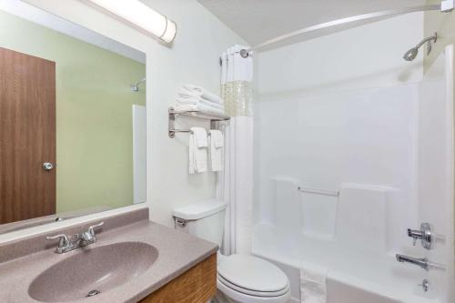 a bathroom with a toilet, sink, and shower at Super 8 by Wyndham North Sioux City in North Sioux City