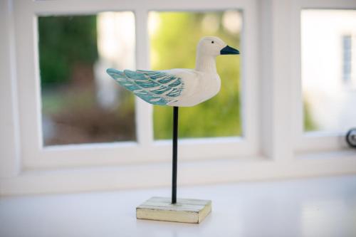 a plastic duck on a stand on a table at Corffe House and Holiday Cottages in Barnstaple