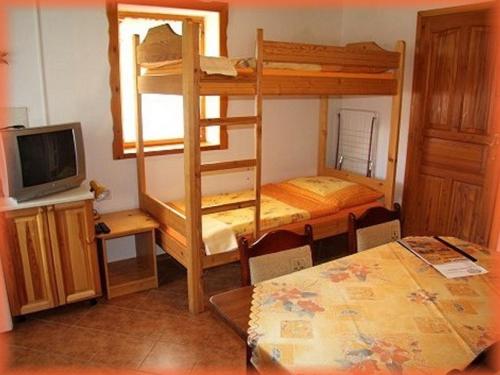 a room with two bunk beds and a table at Motylek 4 in Borušov