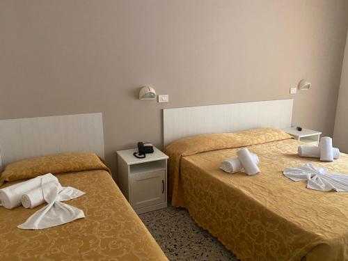 Postel nebo postele na pokoji v ubytování Hotel Modenese