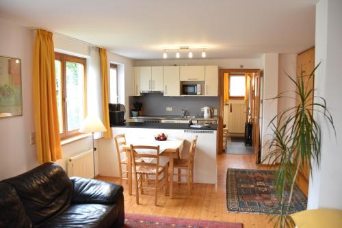 a living room and kitchen with a table and chairs at Apartment Denk in Bregenz