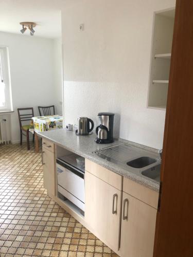 a kitchen with a sink and a counter top at Ferienwohnung Im Bachgrund in Schlitz