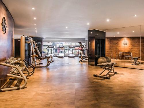 a gym with treadmills and exercise equipment in a building at Pullman Sao Paulo Vila Olimpia in Sao Paulo