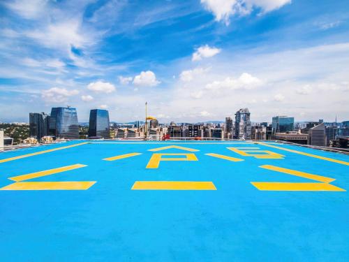 a large swimming pool on the roof of a building at Pullman Sao Paulo Vila Olimpia in Sao Paulo