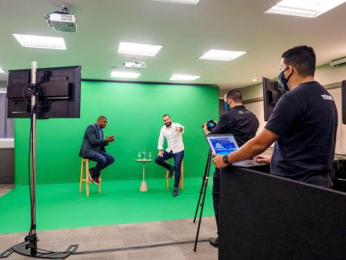 a group of men in an office with a green wall at Pullman Sao Paulo Vila Olimpia in Sao Paulo