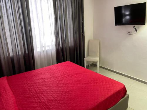 - un lit rouge avec une couette rouge dans une chambre dans l'établissement Napoli Via Toledo, à Naples