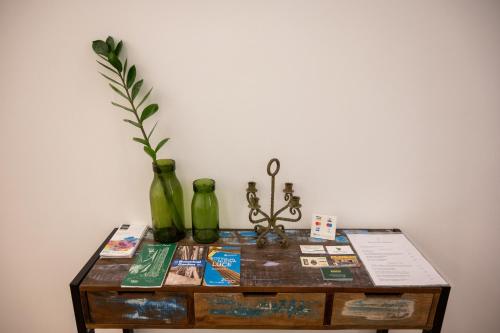 a table with two vases and a plant on it at Ai Tre Mercati in Palermo