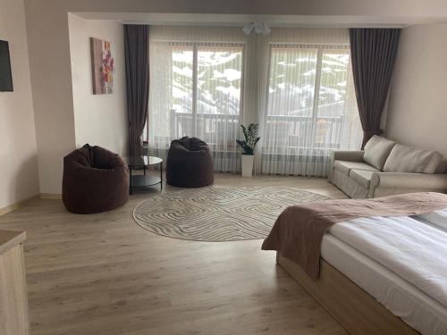 a bedroom with a bed and a living room at Vershyna in Pilipets