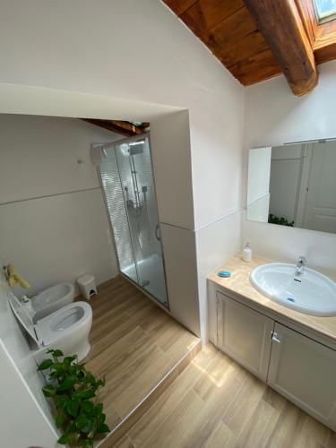 a bathroom with a toilet and a sink and a shower at La Casina in Siculiana