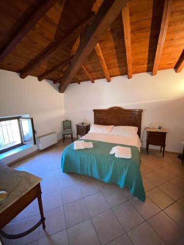 a bedroom with a bed in a room with wooden ceilings at La Casina in Siculiana