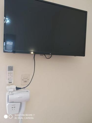 a flat screen tv hanging on a wall at Menelaos Apartments in Lefokastro