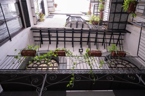 a balcony with potted plants on a building at Ai Tre Mercati in Palermo