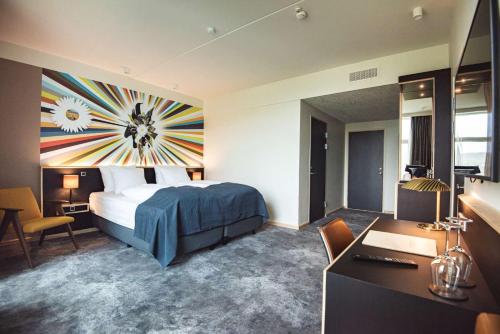 a hotel room with a bed and a desk at Hotel Brandan in Tórshavn