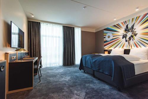 a hotel room with a large bed and a desk at Hotel Brandan in Tórshavn