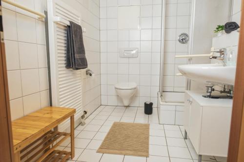 a white bathroom with a sink and a toilet at FullHouse - Dessau - K36 Supreme - Balcony in Dessau