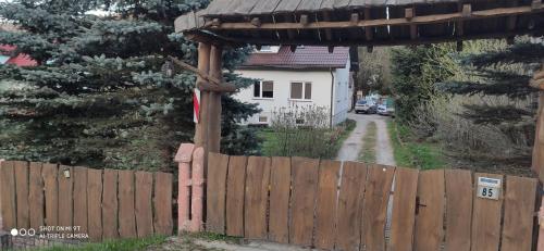 a wooden fence with a gate in front of a house at K85 Komańcza Baza Noclegowa Wypadowa Bieszczady Beskid Niski in Komańcza