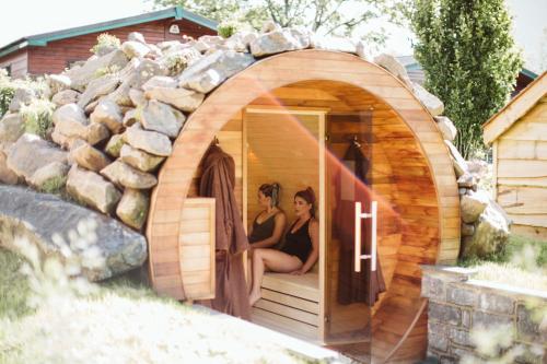 two women are sitting in a hobbit house at Galgorm in Ballymena