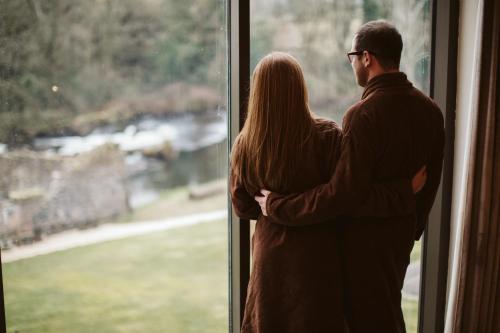 a man and woman standing in front of a window at Galgorm in Ballymena