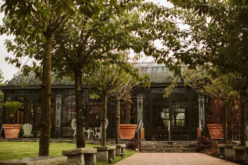 a building with trees in front of it at Galgorm in Ballymena