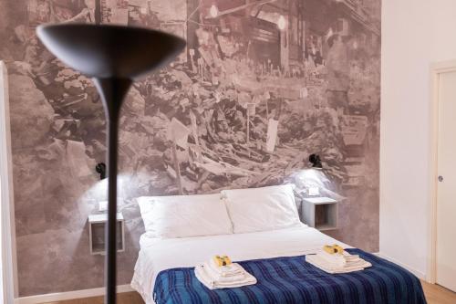 a bedroom with a bed and a wall mural at Ai Tre Mercati in Palermo