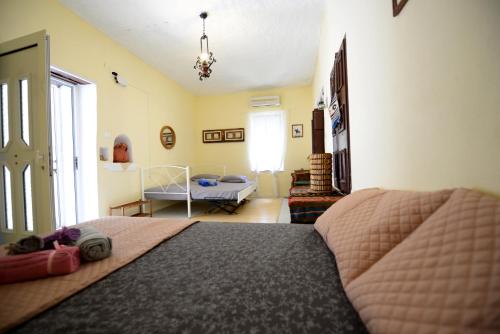 a bedroom with a bed and a living room at Traditional Cretan Country House (9klm from Elafonissi) in Plokamianá