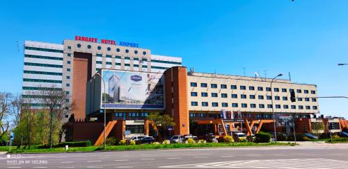 a large building with a clock on the side of it at Sangate Hotel Airport in Warsaw