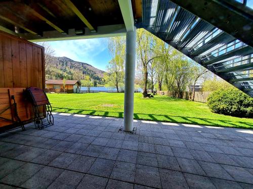 a screened porch with a view of a park at Appartementhaus „die Kuh am See“ (vormals Haus St. Leonhard) in Schliersee