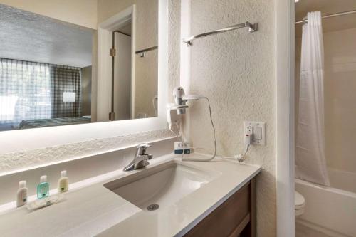 a bathroom with a sink and a mirror at Quality Inn Saint Petersburg North-Tampa Bay in St Petersburg