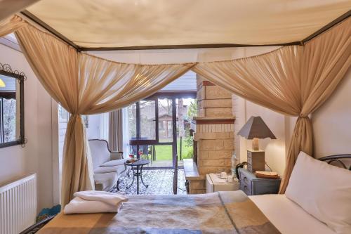 a bedroom with a bed with curtains and a chair at Park Mandalin Hotel - Adult only in Ağva