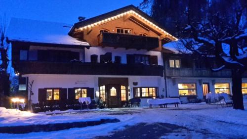 a large house with lights on top of it in the snow at Ferienparadies Spielmannsau in Oberstdorf