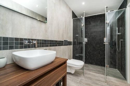 a bathroom with a sink and a toilet and a shower at Old Town 1 Bedroom Oasis with AC and Double Shower in Prague