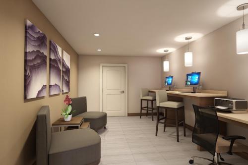 a waiting room of a dental office with chairs and tables at Staybridge Suites - Southgate - Detroit Area by IHG in Southgate