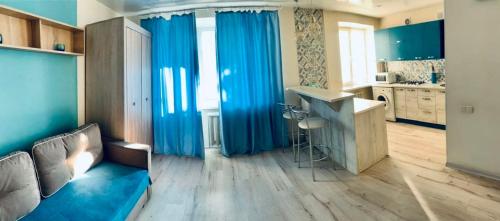 フメリヌィーツィクィイにあるквартира -студия в центреのリビングルーム(青いカーテン付)、キッチン