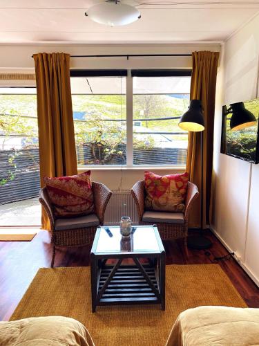 a living room with two couches and a coffee table at Nørre Vissing Kro in Nørre Vissing