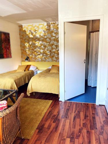 a hotel room with two beds and a door at Nørre Vissing Kro in Nørre Vissing