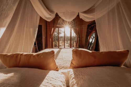 a bedroom with two beds and a window at The Lemon Lodge in Aljezur
