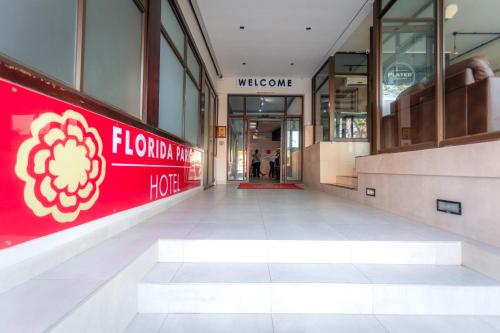 a hallway of a shopping mall with a red sign at Florida Park Hotel, Florida Road in Durban