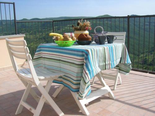 a table with a bowl of fruit on a balcony at Borgo San Pietro in Agnone