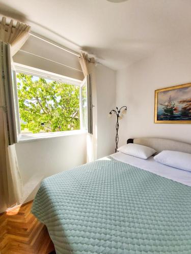 a bedroom with a bed and a window at Mediterranean Olive WaterfallsKRKA-Croatia in Gulin