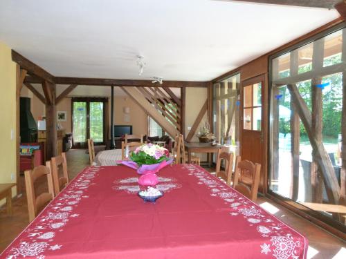 - une salle à manger avec une table rose et des fleurs dans l'établissement Au Milieu de Nulle Part Chambres au lac du Der, à Outines
