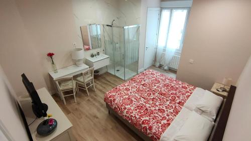a bedroom with a red and white bed and a bathroom at Guggenheim Bilbao Center in Bilbao