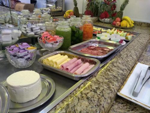 ein Buffet mit verschiedenen Speisen auf der Theke in der Unterkunft Trade Garden Hotel in Araras
