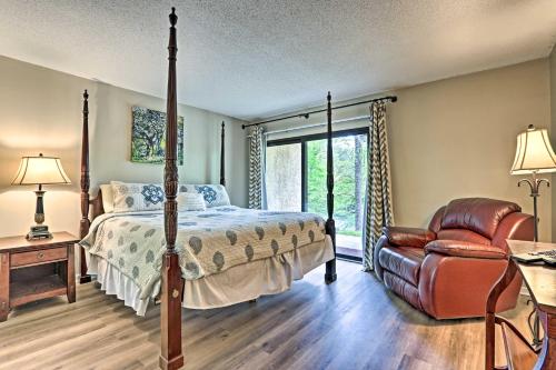 a bedroom with a bed and a chair at Riverside Condo 2 Miles to Smoky Mtns Ntl Park! in Townsend