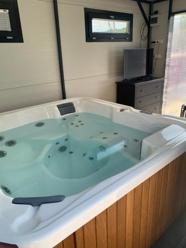 a large bath tub in a room with at Filkes Rezidence in Filkeháza