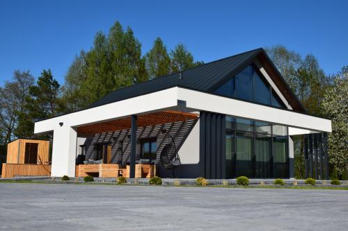 a rendering of a house with a black roof at Szklane Domy Roztocze 2 in Bondyrz