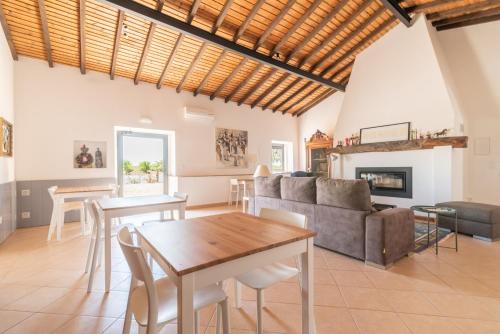 a living room with a table and a couch at Fontes Bárbaras Enoturismo in Entradas